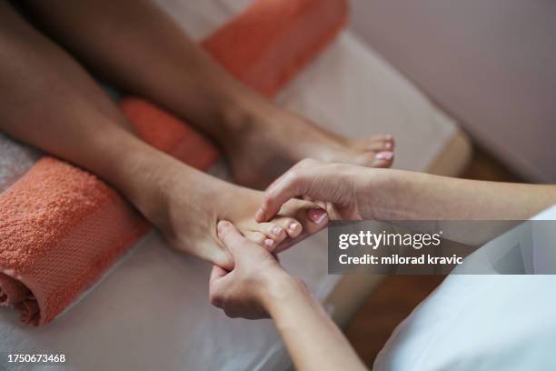 woman making massage in a beauty saloon. concept about spa, relaxation, body care and people. - massage ball stock pictures, royalty-free photos & images
