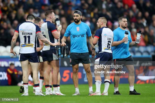 Ade Gardner, coach of England looks on as he supplies drinks to the players during the Autumn Test Series match between England and Tonga at John...