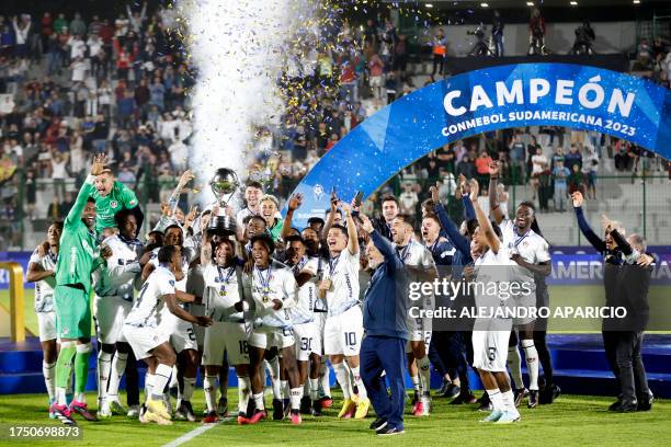 Liga de Quito´s players celebrate with the trophy of the Copa Sudamericana football tournament after the final match between Brazil's Fortaleza and...