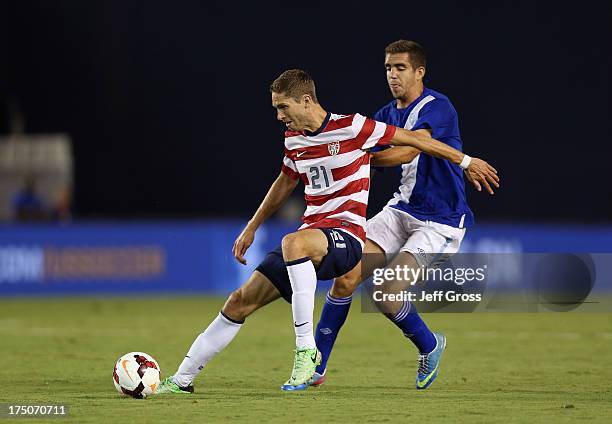 Clarence Goodson of the USA and Minor Lopez Campollo of Guatemala fight for the ball at Qualcomm Stadium on July 5, 2013 in San Diego, California.