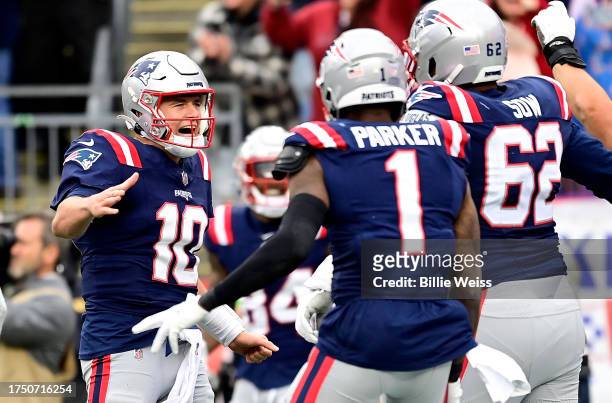 Mac Jones of the New England Patriots celebrates after throwing a touchdown in the fourth quarter of the game against the Buffalo Bills at Gillette...
