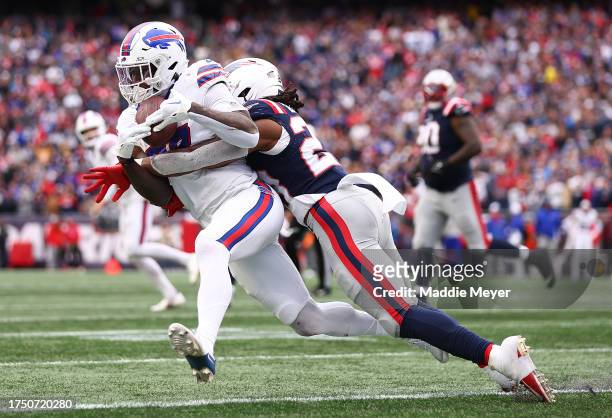Latavius Murray of the Buffalo Bills is tackled with the ball by Kyle Dugger of the New England Patriots in the fourth quarter of the game at...
