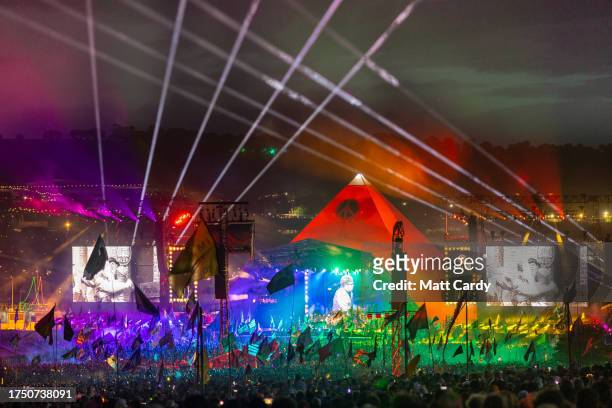 Rainbow colours illuminate the stage as crowds gather to watch Elton John perform on the main Pyramid Stage on Day 5 of the Glastonbury Festival 2023...