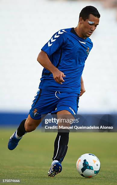 Quique Gonzalez of Valladolid runs with the ball during a friendly match between Abacete and Real Valladolid at Estadio Carlos Belmonte on July 30,...