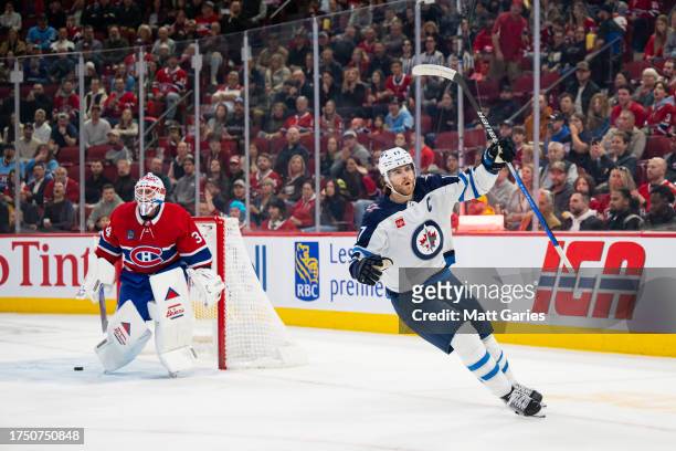 Adam Lowry of the Winnipeg Jets celebrates after a goal during the first period of the NHL regular season game between the Montreal Canadiens and the...