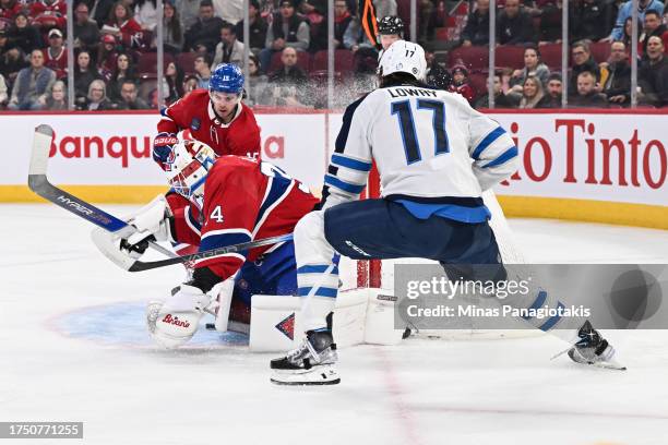 Goaltender Jake Allen of the Montreal Canadiens makes a save on Adam Lowry of the Winnipeg Jets during the first period at the Bell Centre on October...