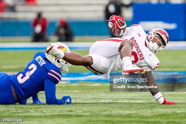 Oklahoma running back Tawee Walker attempts to maintain his balance during the game vs the Kansas Jayhawks and the Oklahoma Sooners on Saturday...