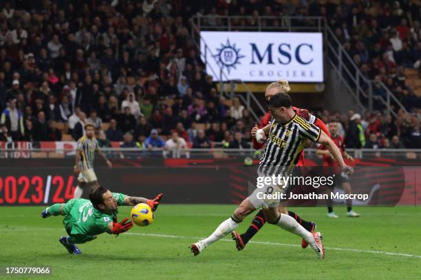 Antonio Mirante of AC Milan dives at the feet of Dusan Vlahovic of Juventus to deny the Serb a second goal for his team during the Serie A TIM match...