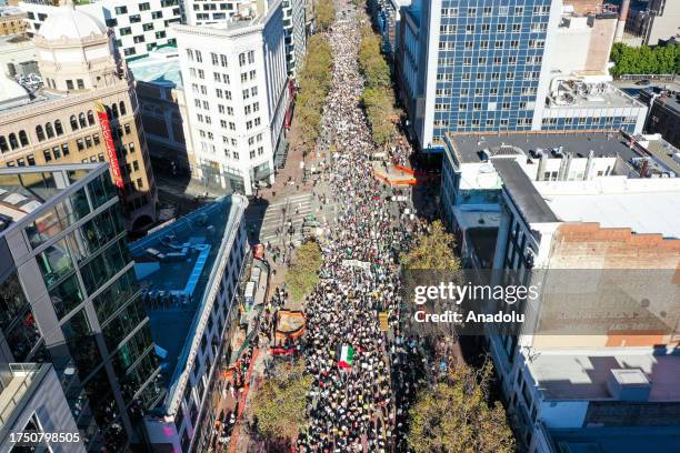 An aerial view of people gathering near the Ferry Building and marching on Market Street on October 28, 2023 in San Francisco, California. Supporters...