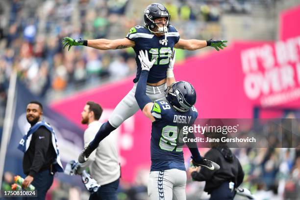 Jake Bobo of the Seattle Seahawks celebrates after scoring a touchdown with Will Dissly of the Seattle Seahawks in the second quarter of the game...