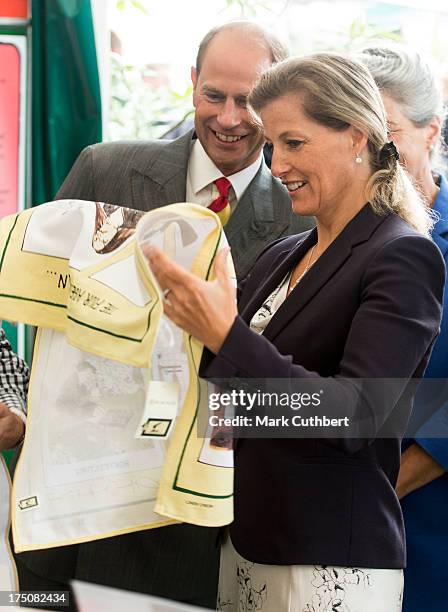 Prince Edward, Earl of Wessex and Sophie Rhys-Jones, Countess of Wessex study a funny tea towell during their visit to the New Forest and Hampshire...