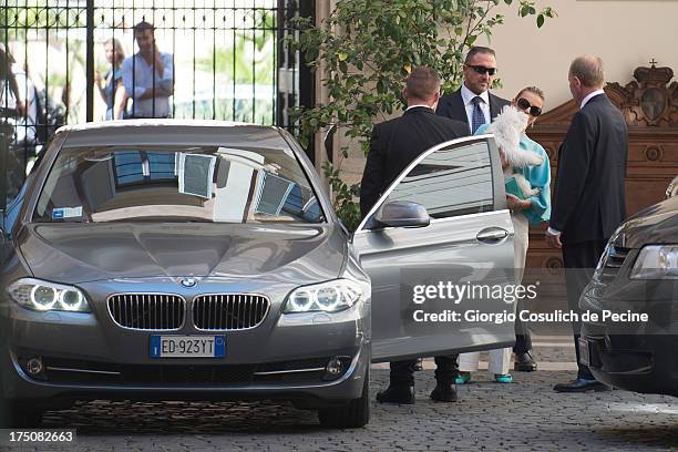 Francesca Pascale , the girlfriend of former Italian prime minister Silvio Berlusconi, plays with a dog as she leaves Palazzo Grazioli on July 31,...