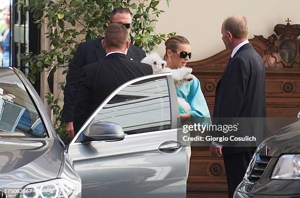 Francesca Pascale , the girlfriend of former Italian prime minister Silvio Berlusconi, plays with a dog as she leaves Palazzo Grazioli on July 31,...