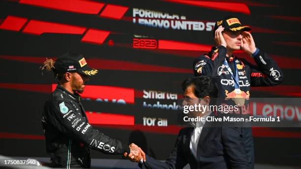 Second placed Lewis Hamilton of Great Britain and Mercedes shakes hands with Mohammed ben Sulayem, FIA President on the podium during the F1 Grand...