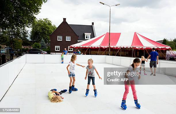 Youthful skaters make the first strokes on an artificial ice skating rink during the Den Driehoek On Ice event in Vinkel, The Netherlands, on July...