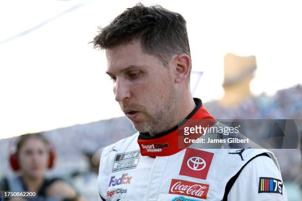 Denny Hamlin, driver of the Sport Clips Haircuts Toyota, walks to the garage area after an on-track incident during the NASCAR Cup Series 4EVER 400...