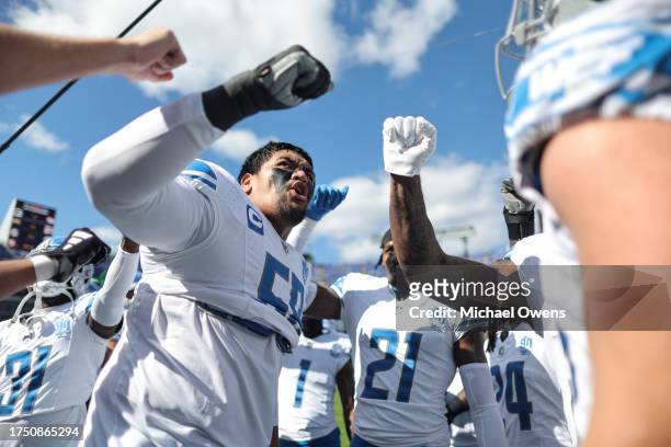 Penei Sewell of the Detroit Lions reacts as he leads a huddle prior to an NFL football game between the Baltimore Ravens and the Detroit Lions at M&T...