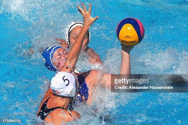 Courtney Mathewson of USA and her team mate Caroline Clark in action with Vivian Sevenich of Netherlands during the Women's Water Polo classification...