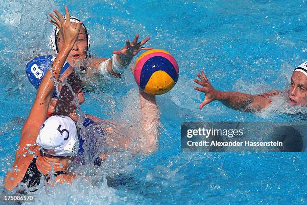 Courtney Mathewson of USA and her team mates Caroline Clark and Lauren Silver in action with Vivian Sevenich of Netherlands during the Women's Water...