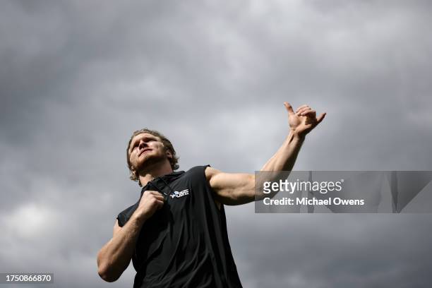 Aidan Hutchinson of the Detroit Lions stretches as he warms up prior to an NFL football game between the Baltimore Ravens and the Detroit Lions at...