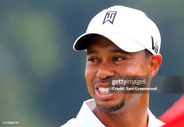 Tiger Woods smiles on the practice range prior to the World Golf Championships-Bridgestone Invitational at Firestone Country Club South Course on...