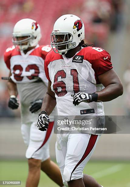 Guard Jonathan Cooper of the Arizona Cardinals practices during the team training camp at University of Phoenix Stadium on July 29, 2013 in Glendale,...