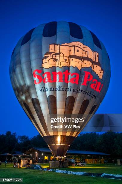 Hot air balloon flying La Fageda d' en Jorda and the volcanic area of Olot, the Natural Park of the Volcanic Zone of La Garrotxa and mountains on the...