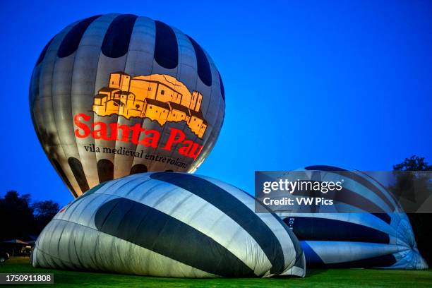 Hot air balloon flying La Fageda d' en Jorda and the volcanic area of Olot, the Natural Park of the Volcanic Zone of La Garrotxa and mountains on the...