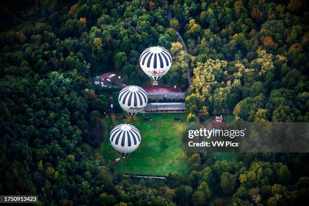 Hot air balloon flying La Fageda d' en Jorda and the volcanic area of Olot, the Natural Park of the Volcanic Zone of La Garrotxa and mountains on the...