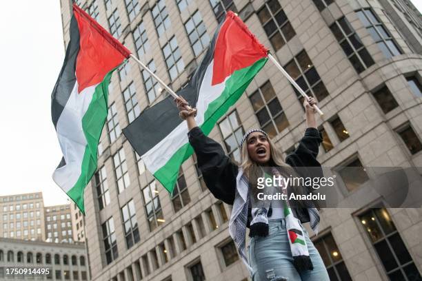 Woman waves the Palestinian flags during march through downtown Detroit, Michigan on October 28 calling for an immediate ceasefire and condemn...
