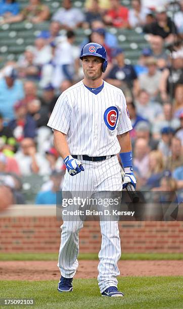 Cole Gillespie of the Chicago Cubs walks back to the dugout after striking out against the Milwaukee Brewers at Wrigley Field on July 30, 2013 in...