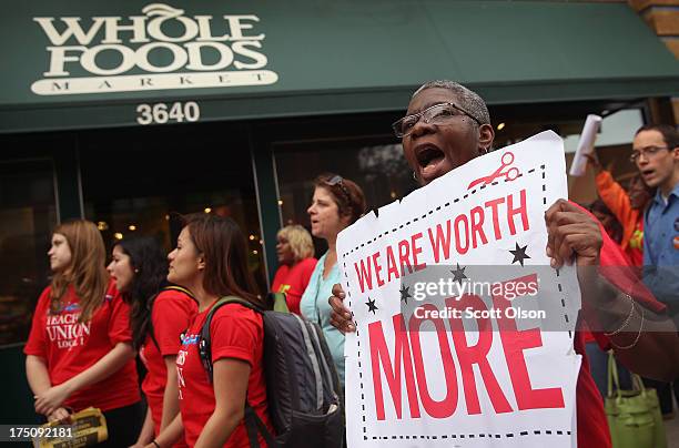 Betty Bailey , of SEIU Local 1, protests with Whole Foods Market employees and other union activists outside a Whole Foods Market store on July 31,...