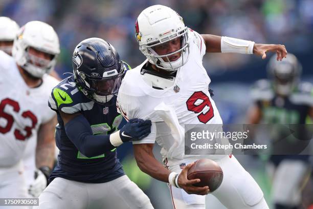 Devon Witherspoon of the Seattle Seahawks tackles Joshua Dobbs of the Arizona Cardinals in the fourth quarter of the game at Lumen Field on October...