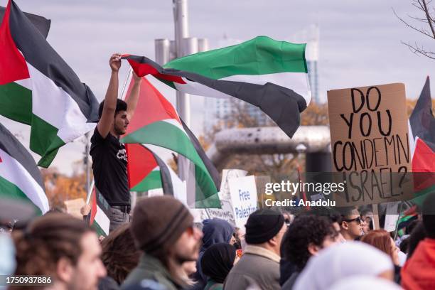 Man waves the Palestinian flag during march through downtown Detroit, Michigan on October 28 calling for an immediate ceasefire and condemn Israeli...