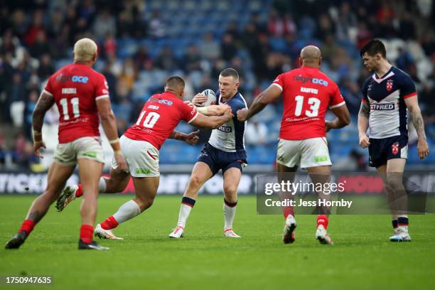 Harry Newman of England is challenged by Tevita Tatola of Tonga during the Autumn Test Series match between England and Tonga at John Smith's Stadium...