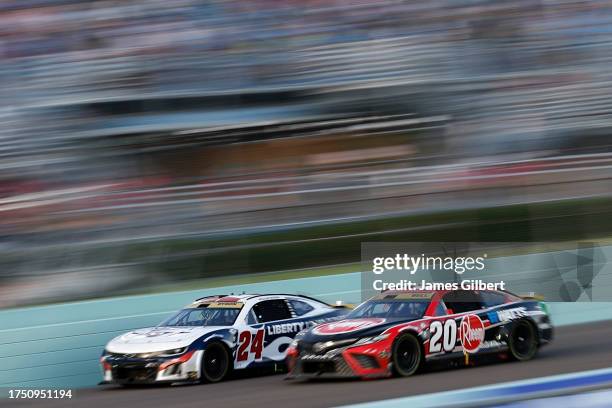 Christopher Bell, driver of the Rheem/Watts Toyota, and William Byron, driver of the Liberty University Chevrolet, race during the NASCAR Cup Series...