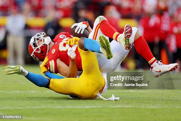Travis Kelce of the Kansas City Chiefs is tackled by Derwin James Jr. #3 of the Los Angeles Chargers during the fourth quarter at GEHA Field at...