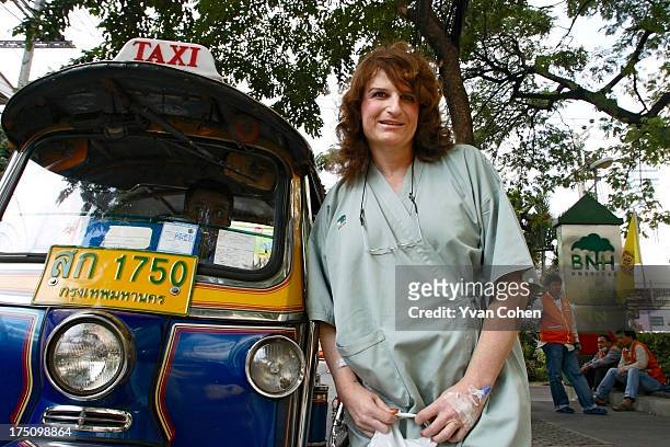 Mandy, a 49-year-old American transexual, stands beside a Tuk-Tuk outside the Bangkok Nursing Home hospital in downtown Bangkok. After years of...