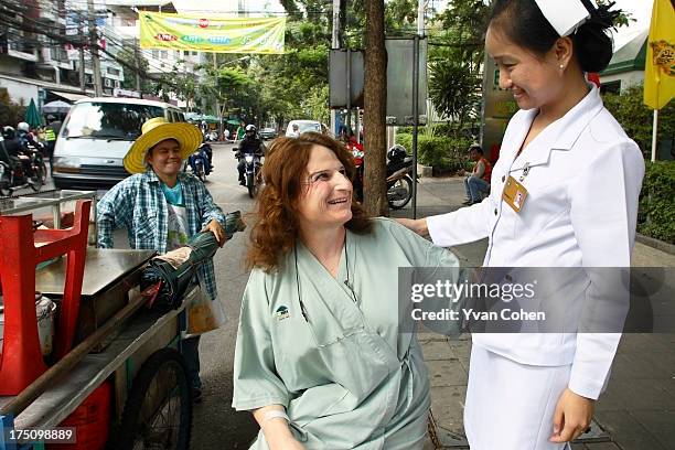 Mandy, a 49-year-old American transexual, talks with her nurse outside the Bangkok Nursing Home hospital in downtown Bangkok. After years of...