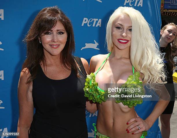 Personality Courtney Stodden poses in a lettuce leaf bikini for PETA with her mother Krista Keller at Hollywood & Highland Center on July 31, 2013 in...