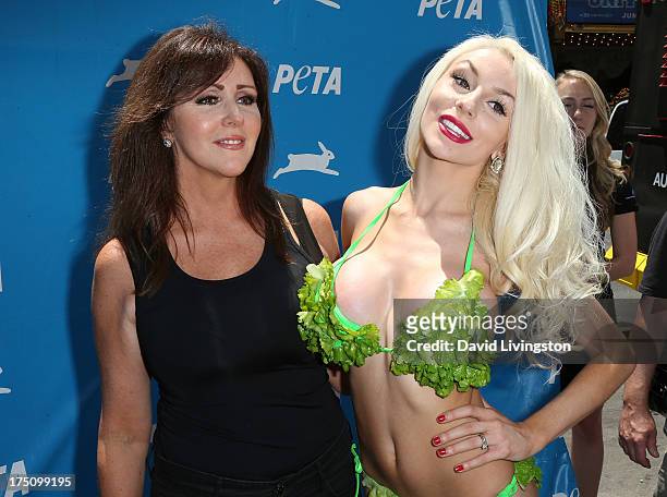 Personality Courtney Stodden poses in a lettuce leaf bikini for PETA with her mother Krista Keller at Hollywood & Highland Center on July 31, 2013 in...