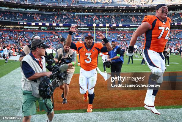 Russell Wilson of the Denver Broncos and Garett Bolles celebrate after the game against the Green Bay Packers at Empower Field At Mile High on...