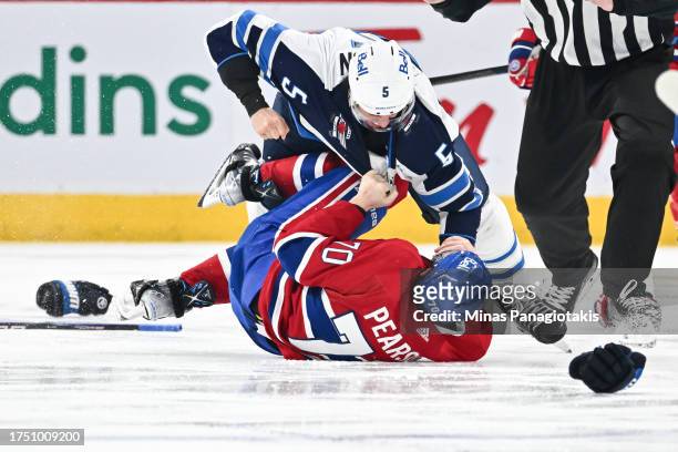 Brenden Dillon of the Winnipeg Jets and Tanner Pearson of the Montreal Canadiens fight during the third period at the Bell Centre on October 28, 2023...
