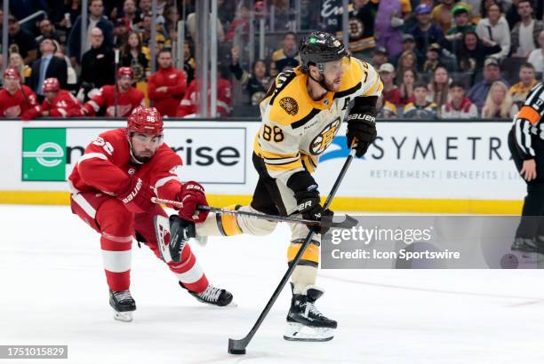 Detroit Red Wings defenseman Jake Walman fouls Boston Bruins right wing David Pastrnak on a breakaway for a penalty shot during a game between the...