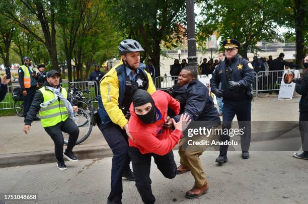 Police intervene a man during the march through downtown streets held by crowds of thousands with the Chicago Coalition for Justice in Palestine to...