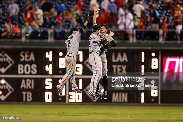 Outfielders Gregor Blanco, Hunter Pence and Roger Kieschnick of the San Francisco Giants celebrate after the game against the Philadelphia Phillies...