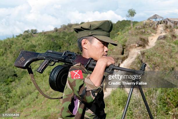 Soldier of the Kachin Independence Army walks with his machine gun on a position located on a hilltop. With its 6,000 troops, the KIA is one of the...