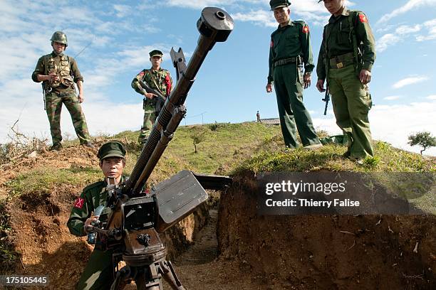 Officers and soldiers of the Kachin Independence Army check a Chinese made anti-aircraft machine gun set on a hilltop. With its 6,000 troops, the KIA...