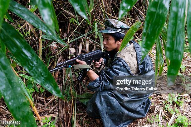 Soldier from the Kachin Independence Army watches down the valley from a hill position to detect the presence of Burmese soldiers. With 6,000 troops,...