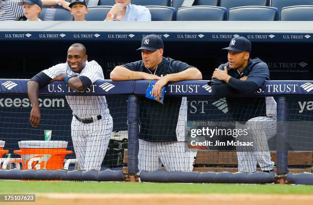 Alfonso Soriano, Kevin Youkilis and Derek Jeter of the New York Yankees look on in the first inning against the Tampa Bay Rays at Yankee Stadium on...